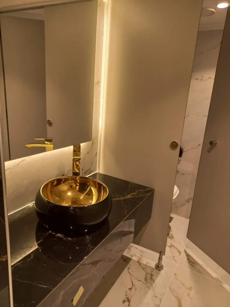 Gold vessel sink on a black marble counter, Sonesta Star Goddess