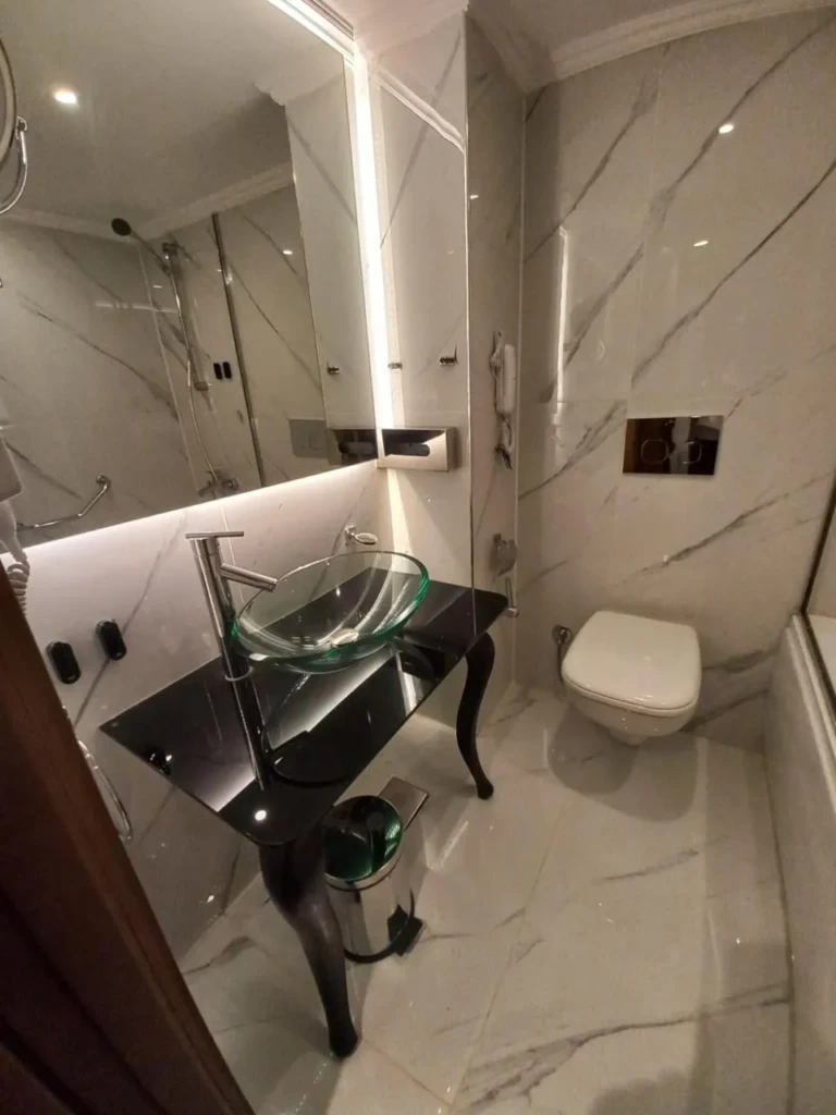 Marble bathroom with glass bowl sink on the Sonesta Star Goddess