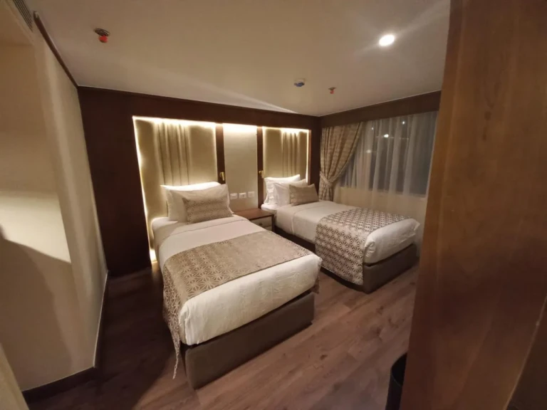 Sonesta Star Goddess twin room seen from the doorway at night