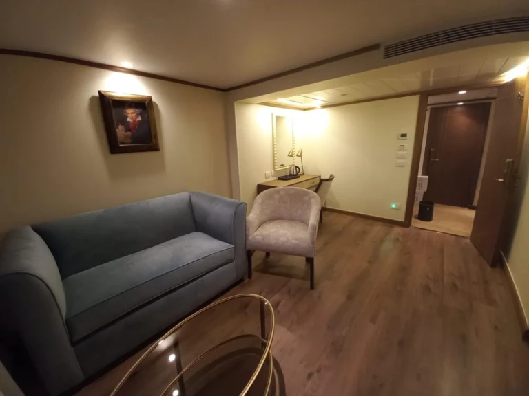 Sonesta Star Goddess suite lounge with grey sofa and glass table