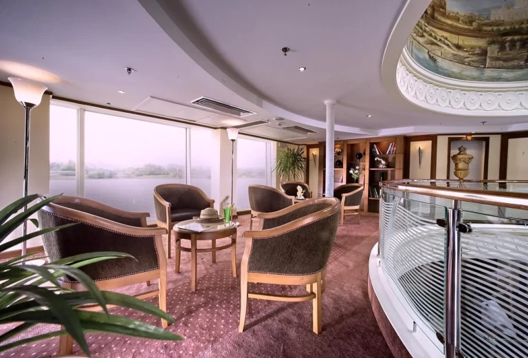 Lounge with armchairs by panoramic windows, Sonesta Star Goddess