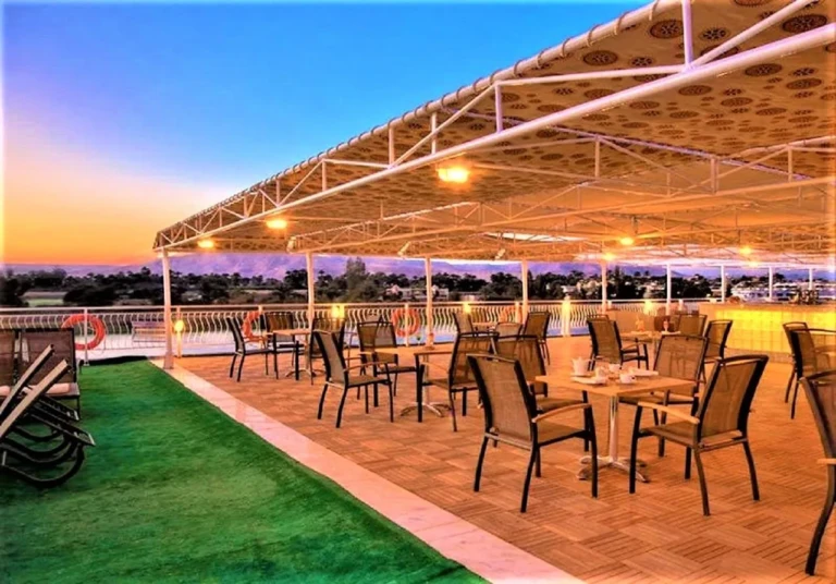 Shaded deck dining tables at sunset on the Steigenberger Legacy