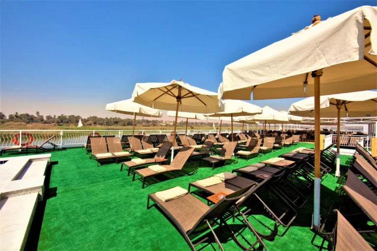 Sun loungers and parasols on green turf, Steigenberger Legacy deck