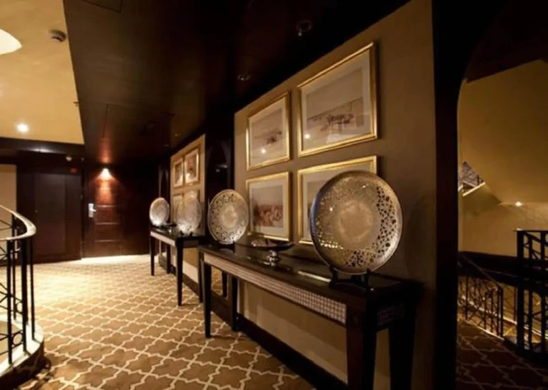 Hallway with silver plates and framed prints on Steigenberger Legacy
