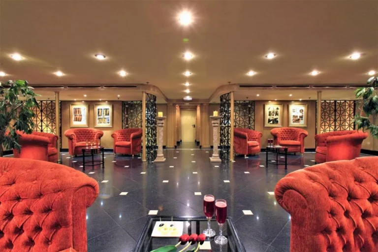 Red tufted armchairs in a lounge on the Steigenberger Royale