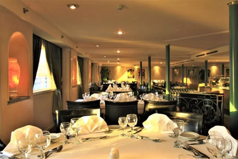 Restaurant with white napkins on set tables on the Steigenberger Royale