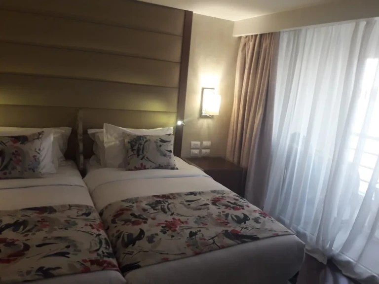 Twin beds with floral covers and sheer curtains on the Sun Goddess
