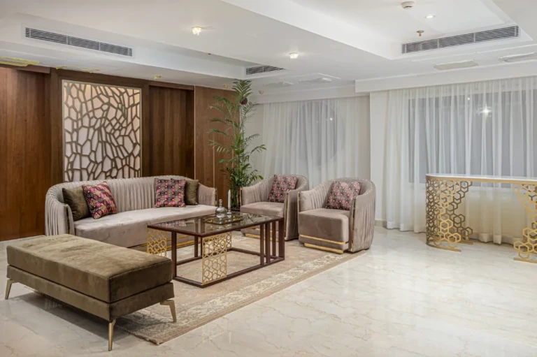 Beige sofas and lattice wall panel in a Sun Goddess sitting area