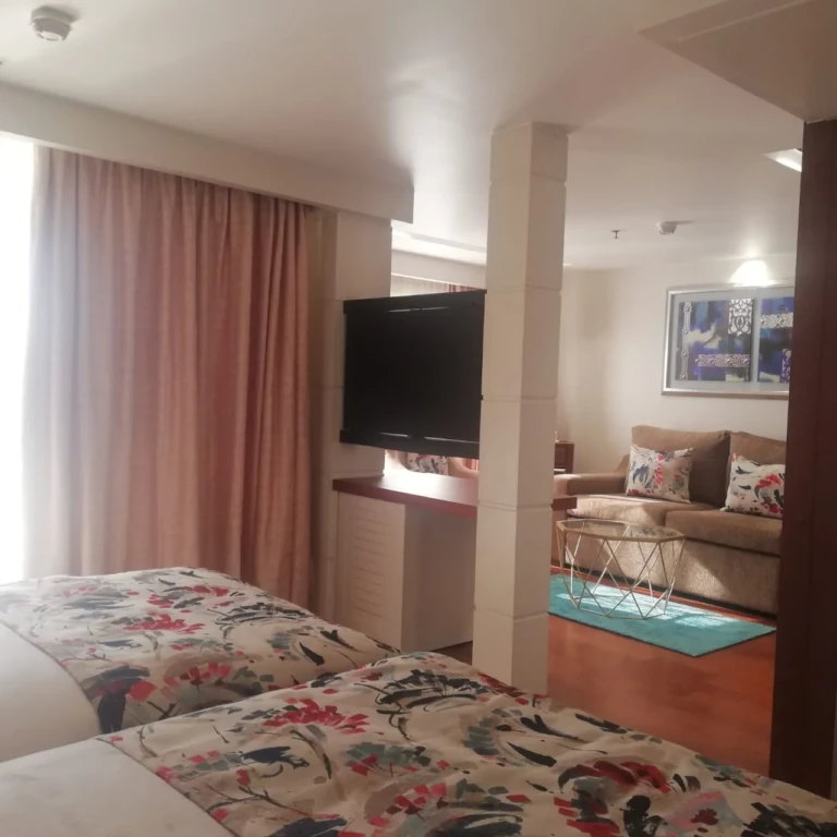 Suite with twin beds, TV and sitting area on the Sun Goddess