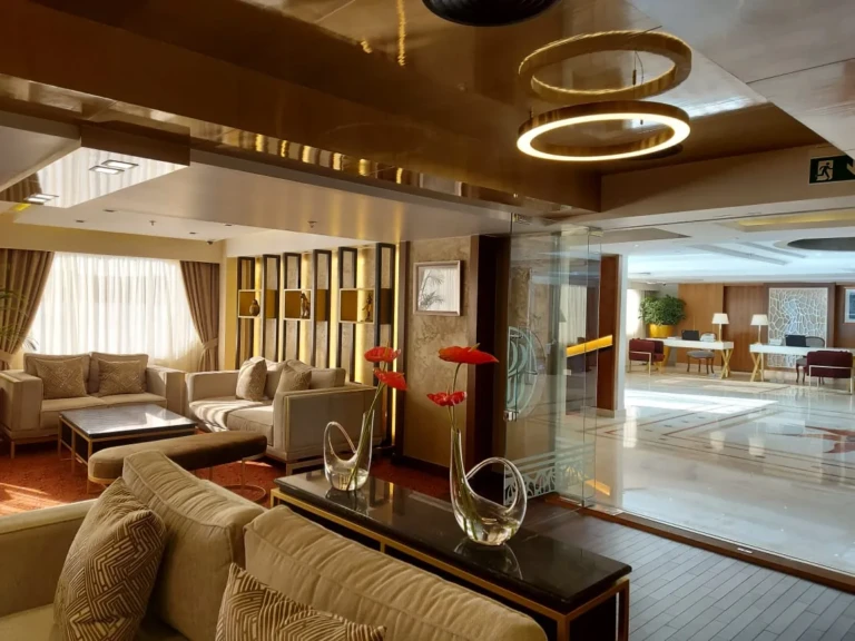 Sun Goddess lounge with sofas, ring lights and glass partition