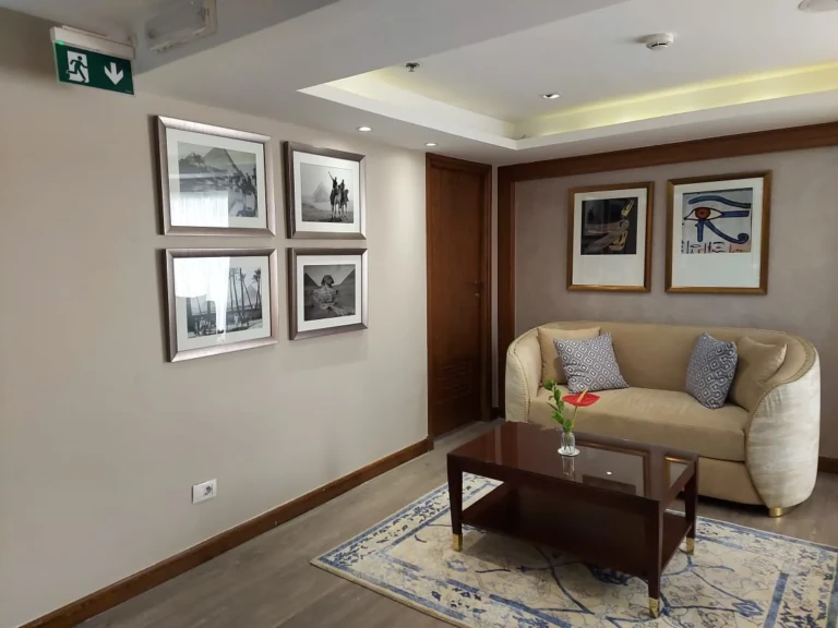 Sofa corner with framed photographs on the Sun Goddess
