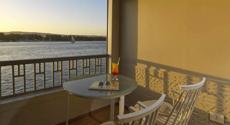 Tulip balcony table with a drink overlooking the Nile at sunset