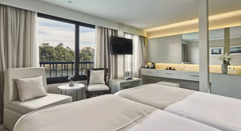Tulip twin cabin with TV, armchairs and balcony doors
