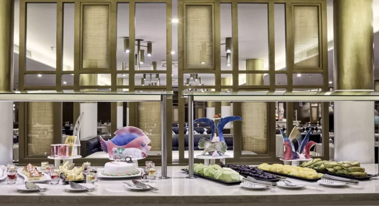 Tulip buffet station with desserts behind glass partitions