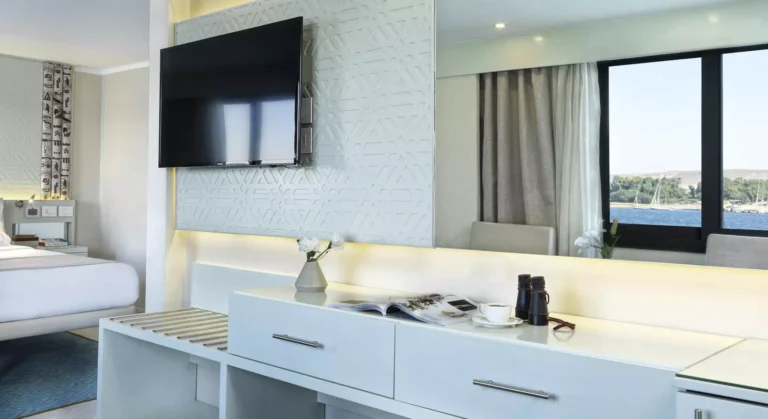 Wall TV above a white dresser in a Tulip river-view cabin