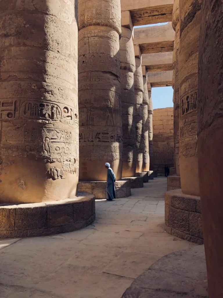 Karnak Temple hypostyle hall columns with a visitor
