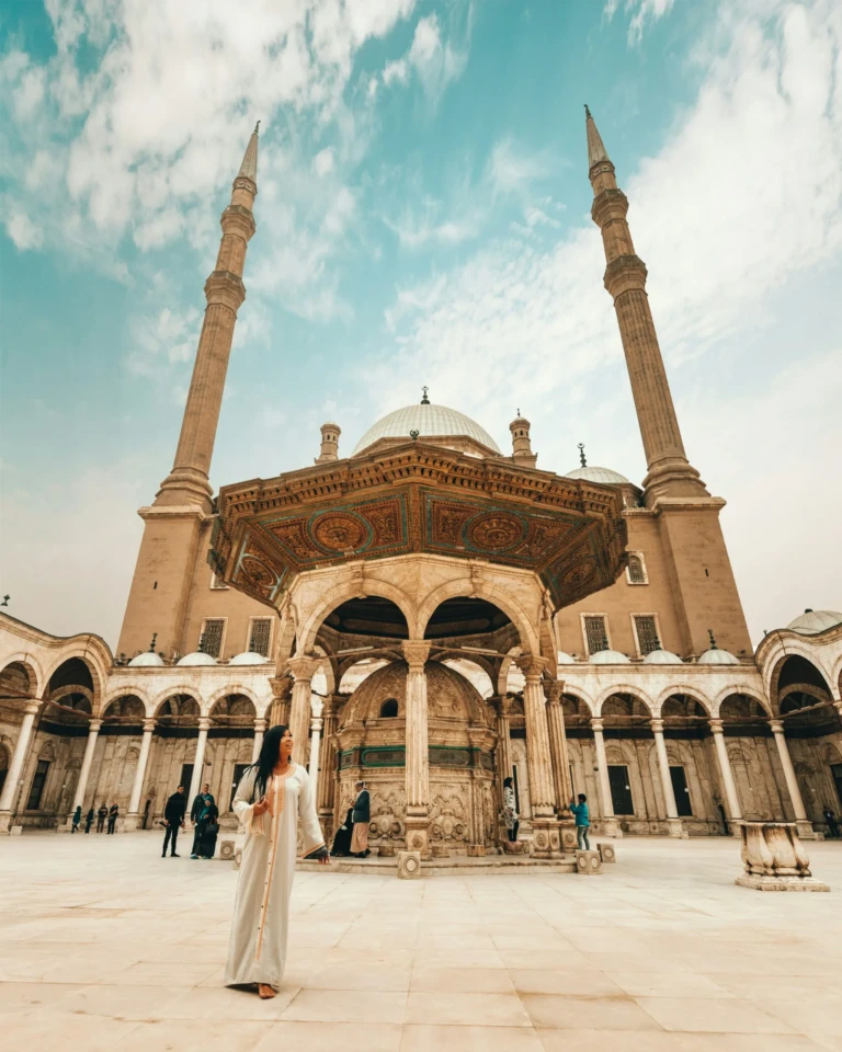 Woman in the Muhammad Ali Mosque courtyard by the ablution fountain