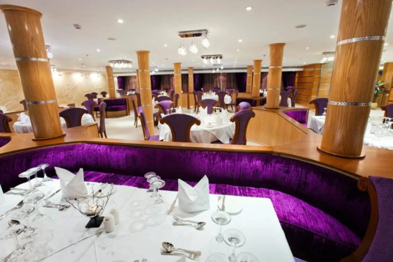 Purple booth seating at a laid table in the Al Hambra restaurant