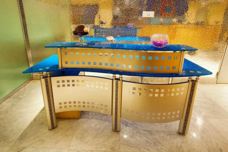 Curved glass-topped reception desk on the Al Hambra