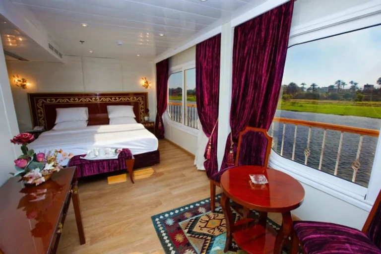 Suite with double bed, red curtains and Nile balcony on the Al Hambra