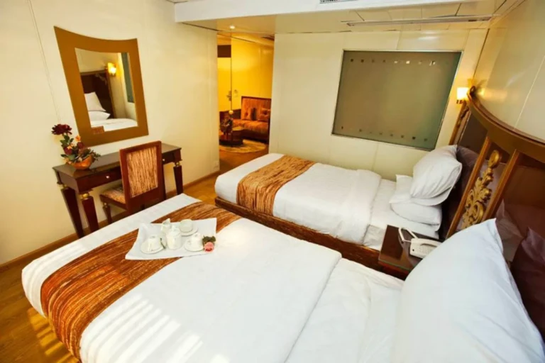 Twin beds and dressing mirror in an Al Hambra cabin