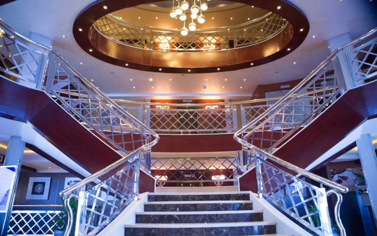 Double staircase beneath a domed ceiling on the Blue Shadow