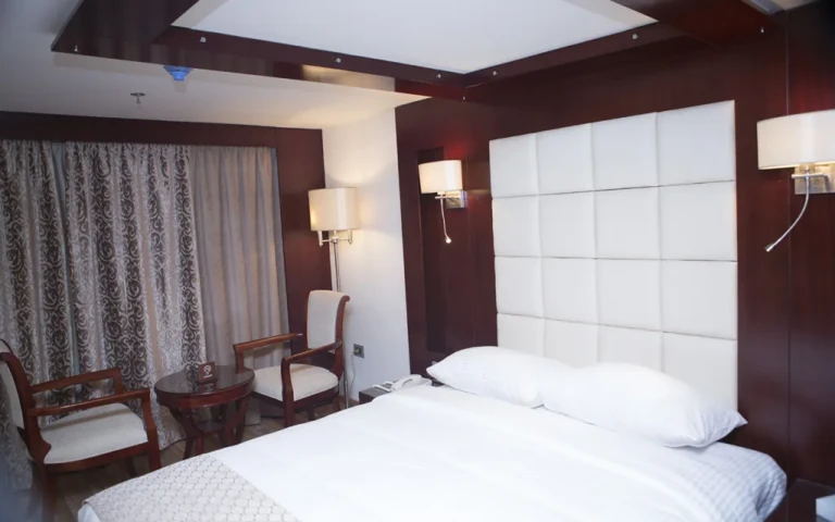 Blue Shadow cabin with padded headboard and two armchairs