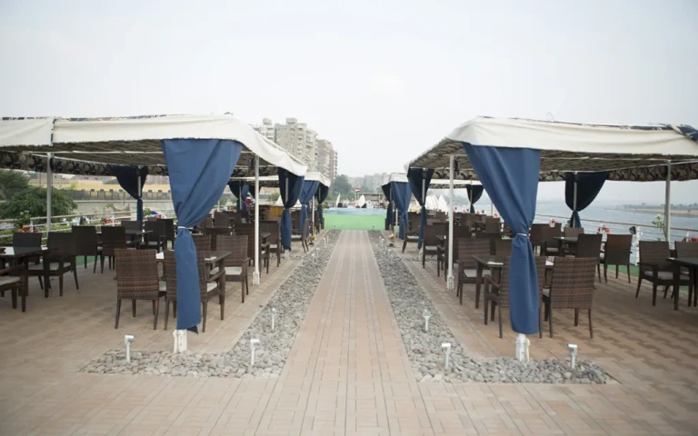 Blue Shadow deck with canopied seating and blue curtains
