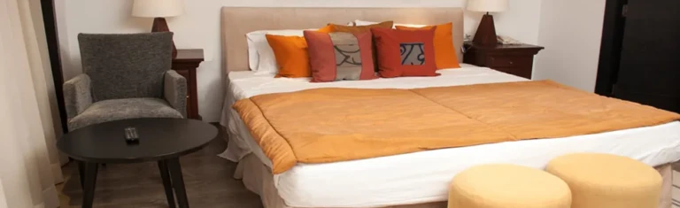 Farida cabin bed with orange throw and cushions