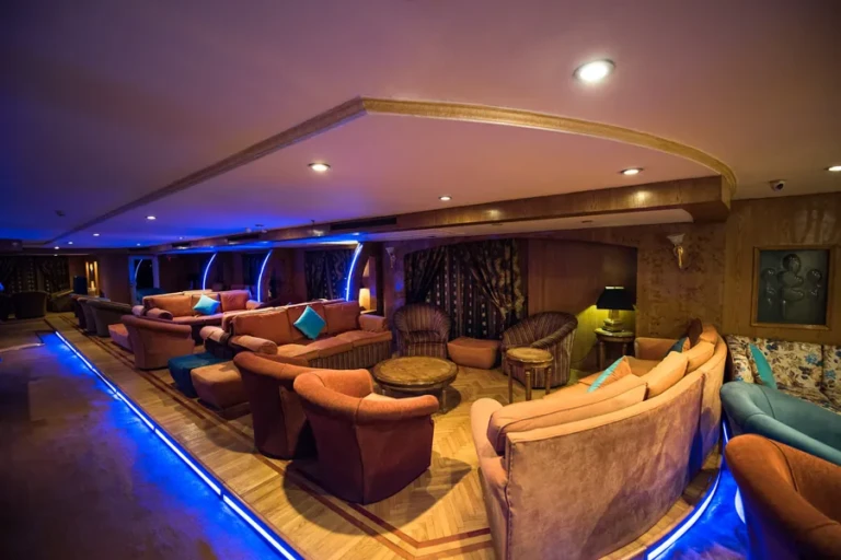 Royal La Terrasse lounge with blue LED lighting and curved sofas