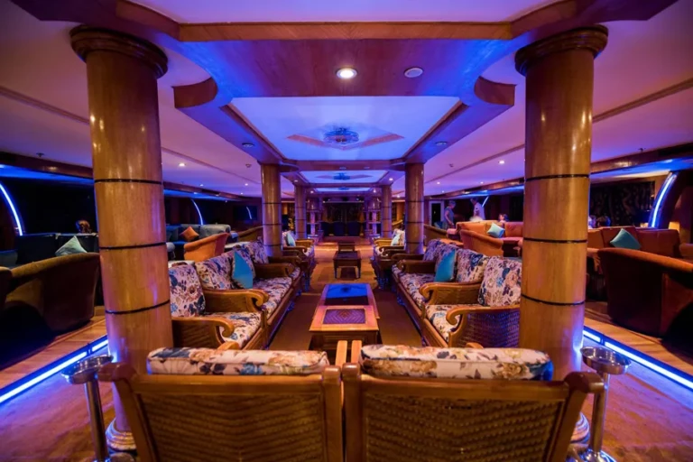 Royal La Terrasse lounge with wooden columns and patterned sofas