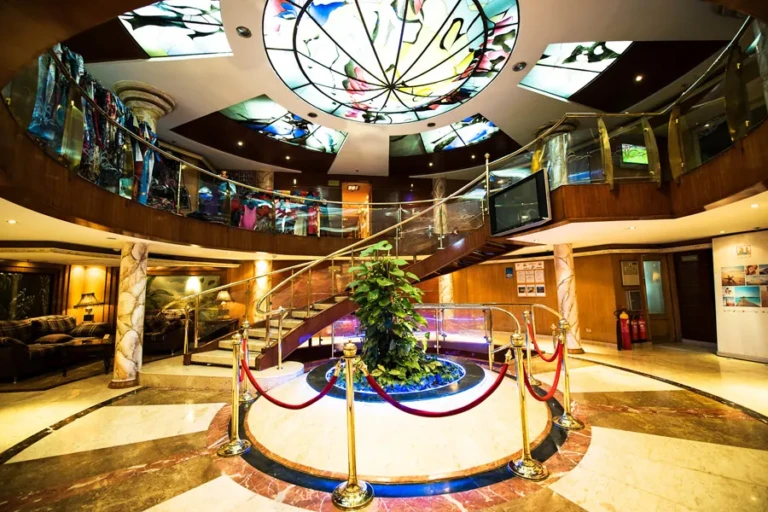 Royal La Terrasse atrium with stained glass dome and staircase