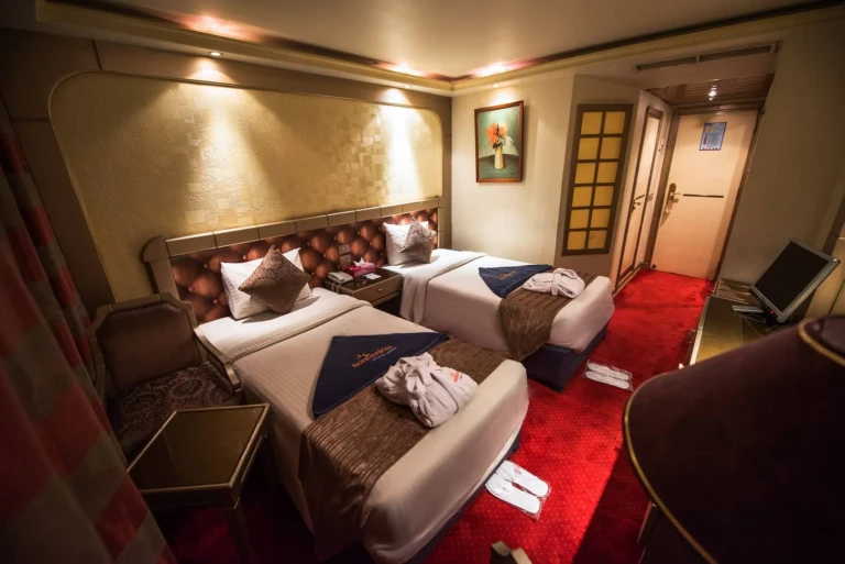 Royal La Terrasse twin cabin with red carpet and towel decorations