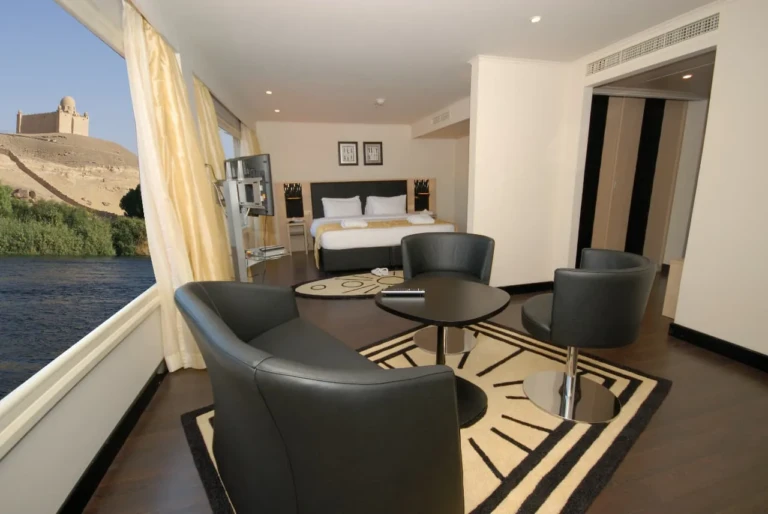 Suite sitting area with leather chairs by a Nile view window