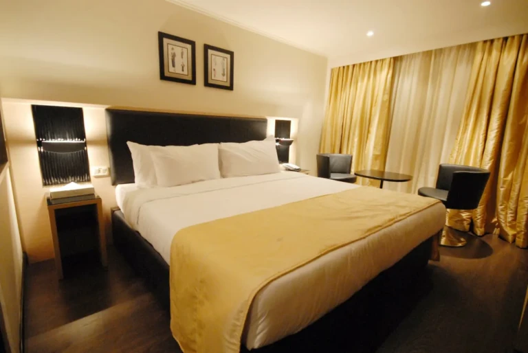 Double bed cabin with gold curtains and dark headboard
