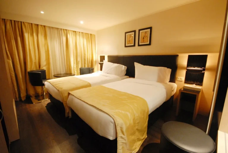 Twin bed cabin with gold throws and curtains