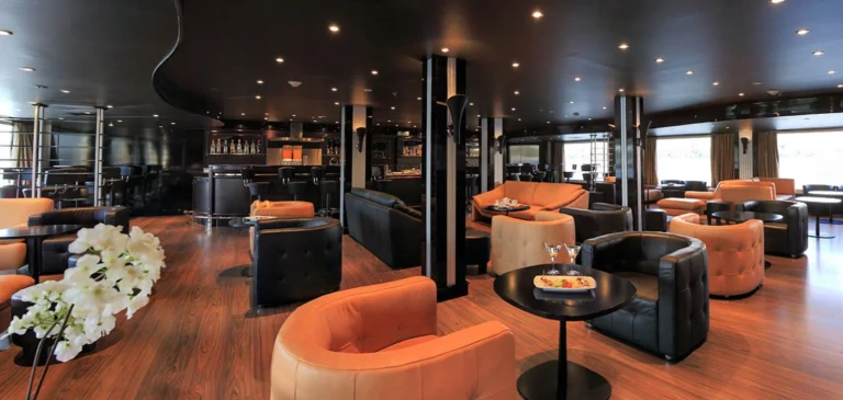Bar lounge with leather armchairs and dark ceiling