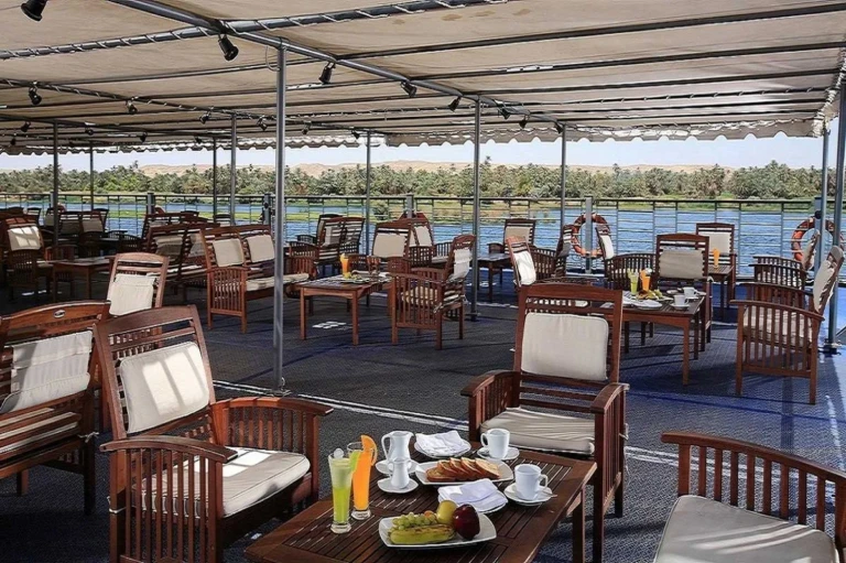 Deck breakfast table with juice beside the Nile