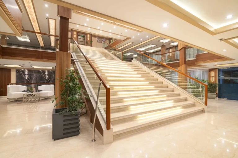 Wide marble staircase with lit steps in the Nile Capital lobby
