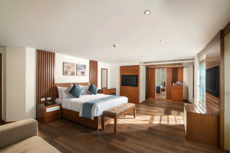 Nile Capital suite with double bed, bench and wood-panelled wall