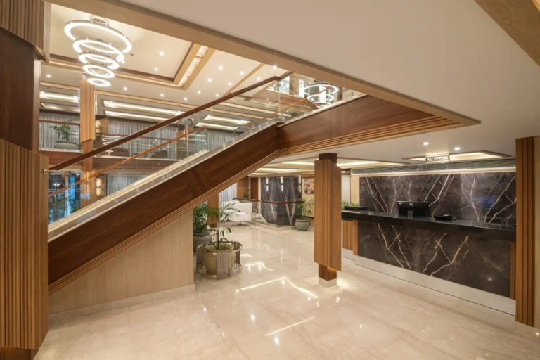 Nile Capital lobby with glass staircase and marble reception desk