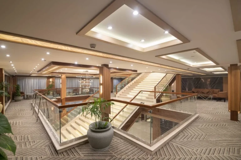 Atrium with glass-railed staircase on the Nile Capital