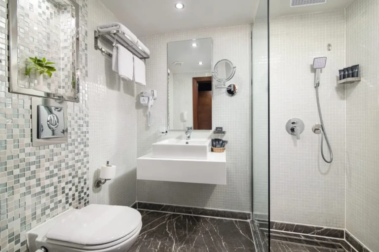 Nile Capital shower room with mosaic wall and white basin