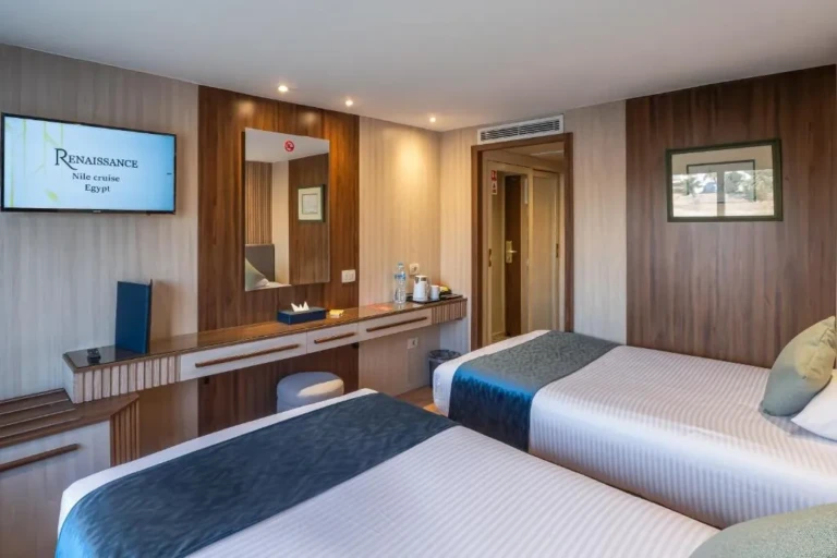 Twin beds and vanity area in a Renaissance cabin