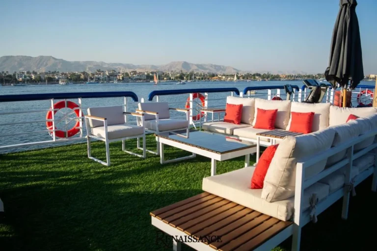 Outdoor lounge with red cushions on the Renaissance deck