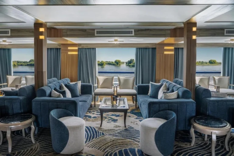 Renaissance lounge with blue sofas and armchairs by river windows