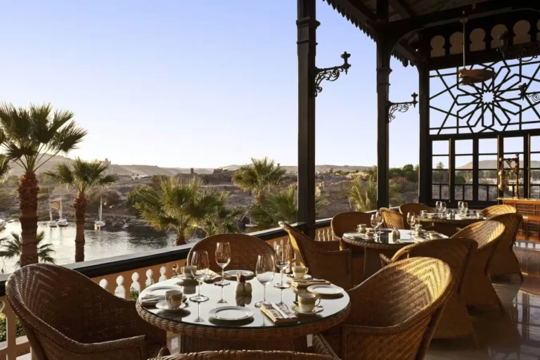 Terrace dining with wicker chairs overlooking the Nile in Aswan