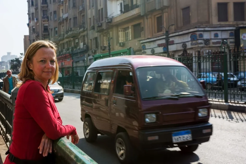 Traveler leaning on a railing on a Cairo street